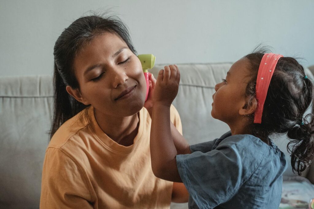 Mother and daughter bond while playing a pretend game indoors.